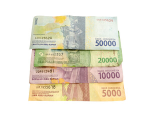 There are four stacks of indonesian rupiah paper currency