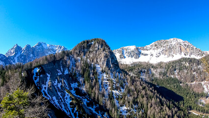 Panoramic view of Karawanks mountain range on sunny day in Carinthia, Austria. Looking at snow...
