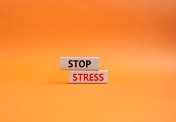 Stop Stress symbol. Concept word Stop Stress on wooden blocks. Beautiful orange background....