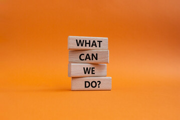 What can we do symbol. Wooden blocks with words What can we do. Beautiful orange background....