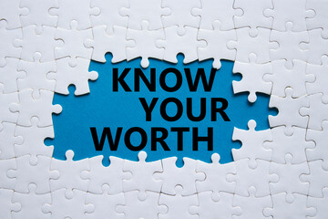 Know your worth symbol. Concept words Know your worth on white puzzle. Beautiful blue background....