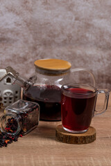 tea in a cup ,a cup filled with tea next to a jug with tea and dry tea poured from the jar,