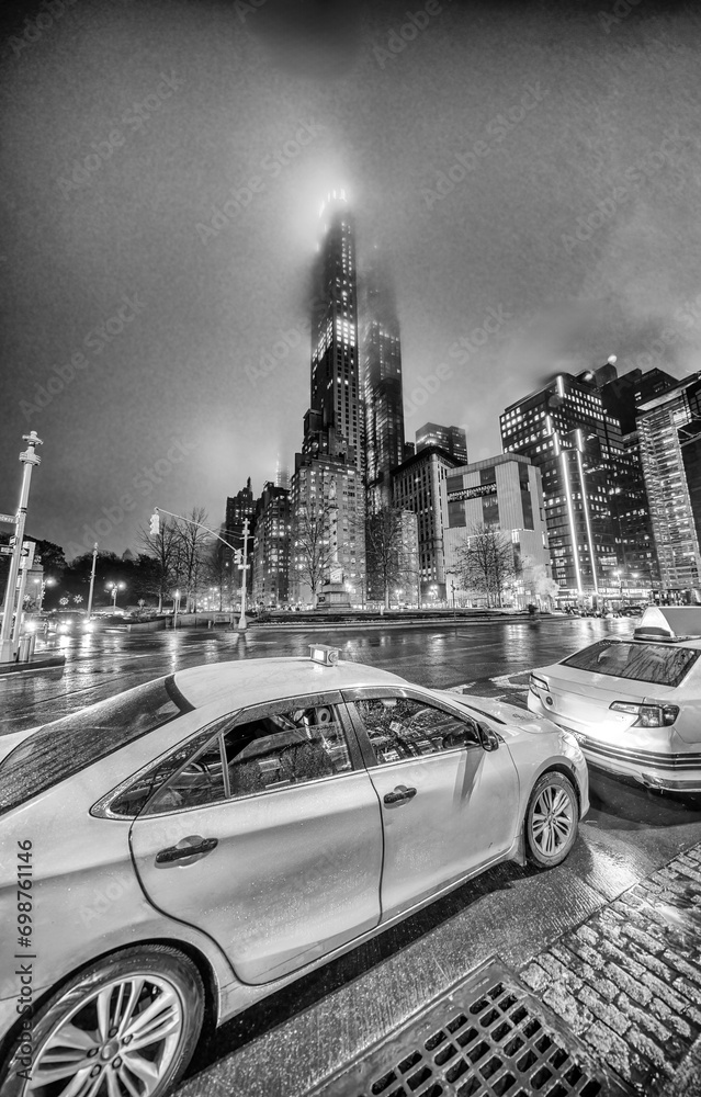 Poster columbus circle skyscrapers and taxi cabs at night, midtown manhattan - new york city