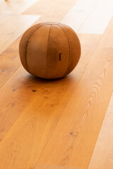 Medizinball aus Leder auf einem Holzboden