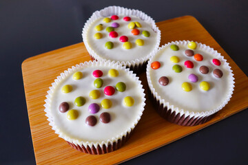 Easter background. small Easter cupcakes and chocolate eggs