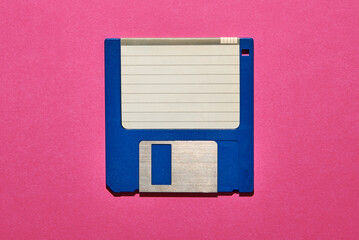 Blank paper on floppy disk in pink studio