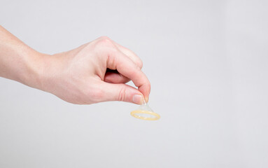 Condom in a man's hand, a means of contraception