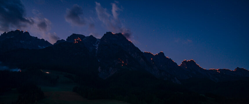 During the Johanni festival, a Christian tradition, people celebrate on the mountain peaks of Wilder Kaiser by enlighting big fires in Austria during July..