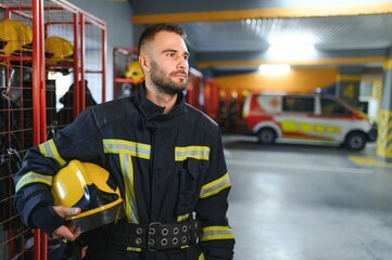 A firefighter puts on a fire uniform at the fire department