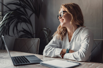 Smiling young caucasian business woman head shot portrait. Thoughtful millennial businesswoman looking away with pensive face, dreaming, thinking over project tasks, future lifestyle.