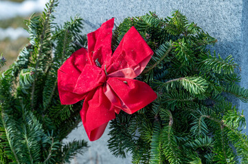 red ribbon on wreath at a cemetery