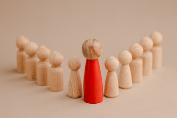 wooden figure representing a leader leading other figures. Leadership concept
