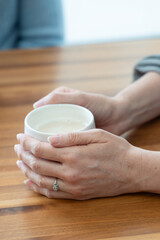 close up of a person holding a cup of coffee