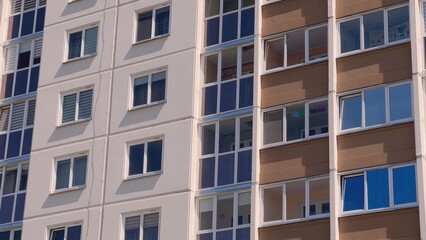 Fototapeta na wymiar The windows of a residential high-rise building.