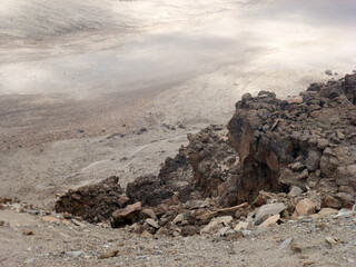 A large pile of stones in the misty mountains. Desert landscape