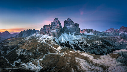 Stunning sunset with colorful sky at Italian Dolomites. Impressive Cadini di Misurina mountain range in autumn colors. 
