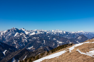Scenic view on snow capped mountain peaks of Karawanks, Julian and Kamnik Savinja Alps in Carinthia...