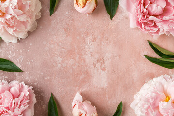 Flower composition. Frame made of pink peony flowers on peach color background. Flat lay. Top view....