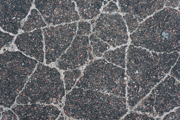 Background, texture, top view of wet asphalt with cracks on the road. Photography, abstraction.