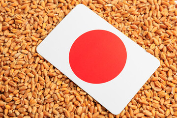 Japan flag on a background of wheat grains. Concept of grain deal and world food security. Texture