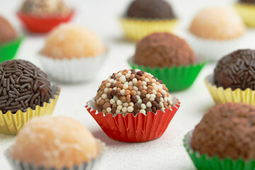 Typical Brazilian sweet brigadeiro. Assorted flavors of candies on a white table