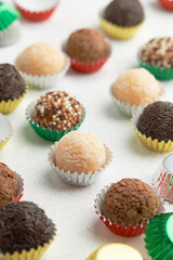 Typical Brazilian sweet brigadeiro. Assorted flavors of candies on a white table