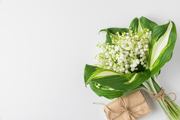 Lily of the valley flowers bouquet with gift box on white background. Womens day, Valentines day...