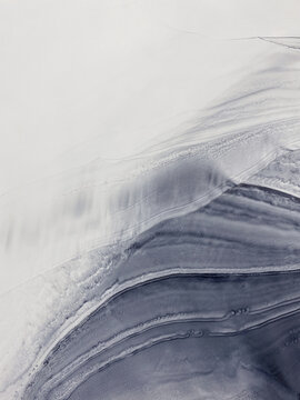 Abstract fluid art in grey, beige, and black with subtle gold accents. Alcohol ink, organic swirls, marbling effect. No real property or natural materials depicted.