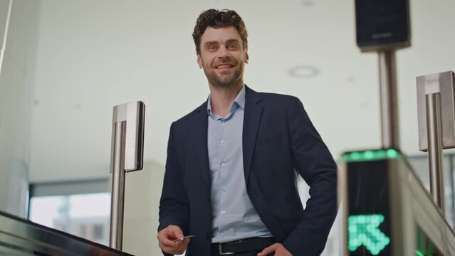 Business man swiping keycard passing office security control. Smiling manager 