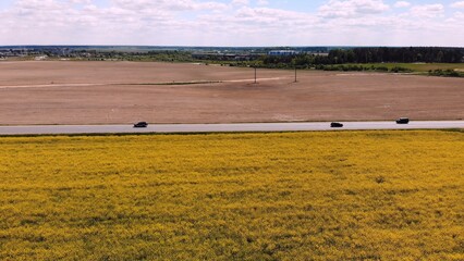 Naklejka premium Aerial drone capture image of brilliant bright yellow rapeseed field.