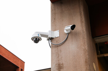Security camera overlooking urban street, surveillance technology, safety monitoring, privacy, urban security