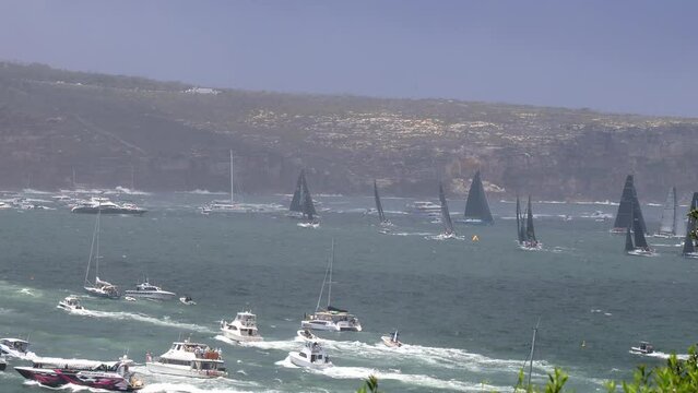 Sail yachts turning on Sydney harbour clearing the heads to Hobart in a race 4k.
