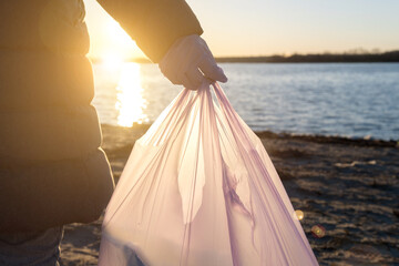 volunteers clean up trash on the beach. environmental problems of plastic in the ocean. 