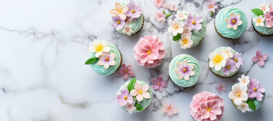 Obraz na płótnie Canvas Spring Cupcakes on a Marble Counter Shot From Above