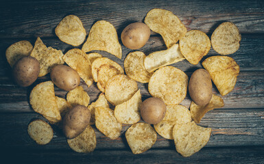 Fototapeta na wymiar Crispy and salty chips on a wooden table