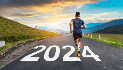 New year 2024 concept, beginning of success. Text 2024 written on asphalt road and male runner preparing for the new year. Concept of challenge or career path and change - obrazy, fototapety, plakaty