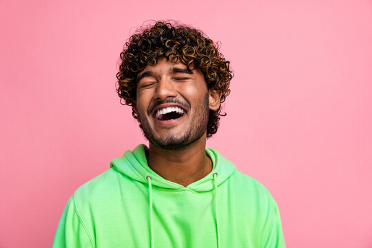 Photo portrait of funny young happy guy laughing when his friend joking humor at stand up show isolated over pink color background