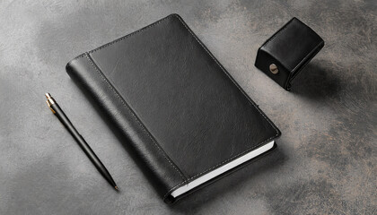 Mockup of a black diary in a leather cover with a pen and a pencil on the table without a logo. A5 notebook