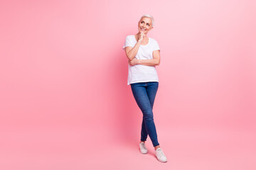 Full size photo of minded woman with short hair wear white t-shirt jeans look empty space think...