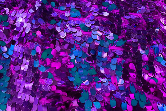 Purple sequins in the form of hearts on the background of sequins.