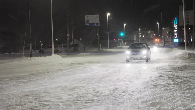 Hokkaido, Japan - December 20, 2023: Blizzard or snowstorm on a street in Wakkanai, Hokkaido, Japan
