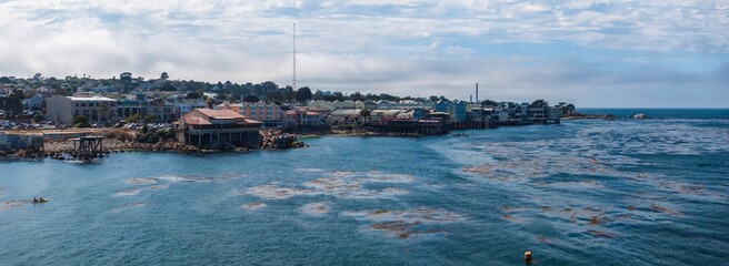 Beautiful aerial view of the Monterey town in California with many yachts docked by the pier.
