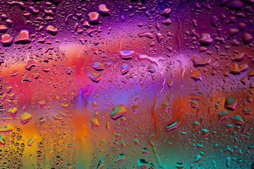 Water drops on glass. Raindrops on the window. Abstract background. Colorful spots. Texture of drops. Selective focus