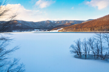 Hokkaido, Japan - December 23, 2023:  Lake Kanayama viewed from a train of Furano Line in Hokkaido, Japan - obrazy, fototapety, plakaty