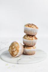 almond muffins on a white plate, homemade bakery style almond muffins on a white background