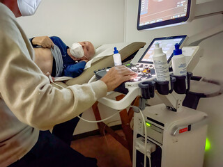 Elderly man in hospital for cardiac ultrasound