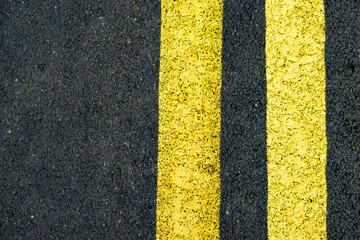 Asphalt road with yellow line marks
