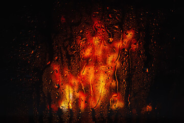 Raindrops on the window. Water drops on glass. Abstract background. Fire flame. Drops texture