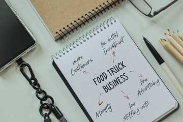 Benefits of Food Truck business over regular restaurants concept on notepad.