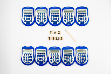Tax time concept, many calculators and tex blocks with inscription 
